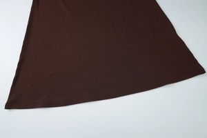 Detailed view of the dark brown dress hem stitching and high-quality fabric texture