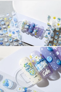 Macro shot of 3D embossed nail stickers featuring blueberry cake and milk bottle motifs