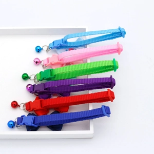 Adjustable nylon pet collars with bowties and bells in six vibrant colors on white tray