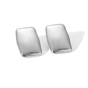 Macro shot of silver rectangular curved earrings with high-polish metallic texture