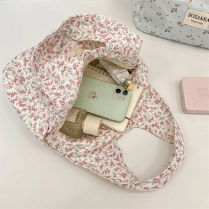 Spacious floral canvas tote bag showing interior storage for phone and accessories