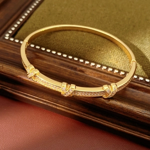 Detailed macro view of 18k gold plated knot bracelet with cubic zirconia paving