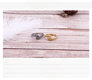 Detail view of gold and silver snake rings with material and weight specifications
