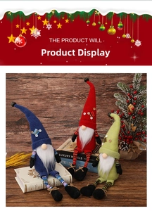 Three Christmas long-legged gnomes in red, blue and green on a wooden surface