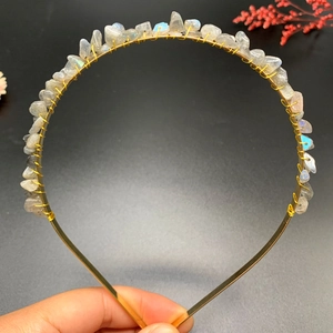 Detail of handmade gold crown headband featuring natural grey crystal stones with blue sheen