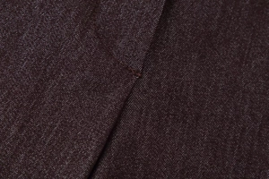 Détail de couture contrastée sur un tissu en coton sergé foncé pour ensemble