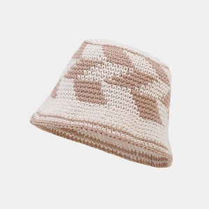 Detailed close-up of handmade crochet bucket hat with beige and brown checkerboard weave
