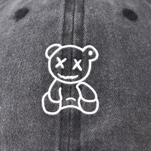 Vintage washed cotton baseball cap featuring a white embroidered cartoon bear on the front