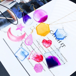 DIY crystal resin pendants in heart and star shapes with glitter and gradient finishes