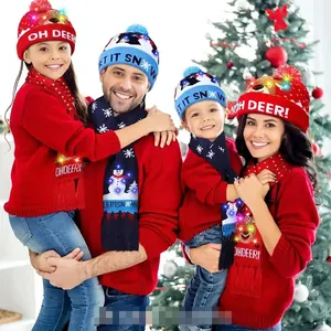 Detail of Christmas knitted hat and scarf set with glowing LED lights and elk patterns