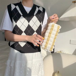 Detail of soft yellow and white quilted bubble texture on a portable stationery pouch