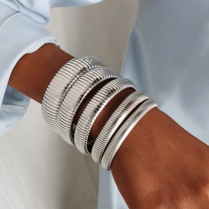 Polished silver stacked multilayer stainless steel spiral bracelet cuff on a wrist