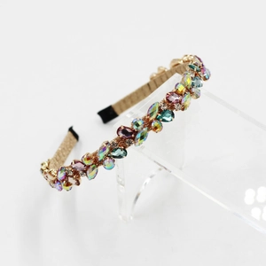 Macro detail of gold-finish headband featuring multi-colored marquise crystals and non-slip tips
