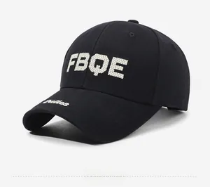 Detail of black baseball cap featuring white towel embroidery FBQE and Dallas script lettering
