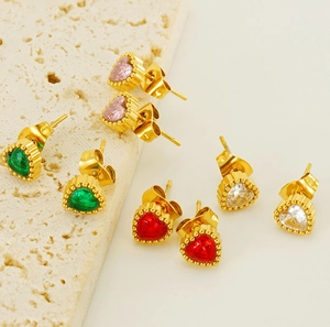 Detail of four pairs of heart-shaped zircon earrings in gold beaded settings