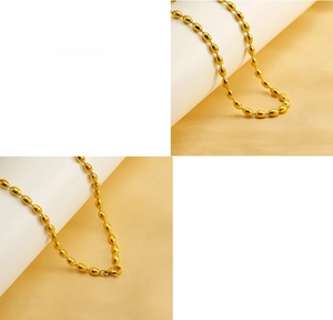 Detailed macro view of golden oval bead necklace made of high-quality titanium steel
