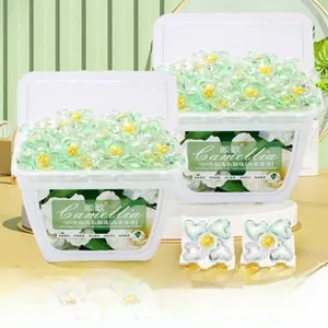 Close-up of 5D multi-chamber camellia scented laundry pods in petal shape and dual boxes