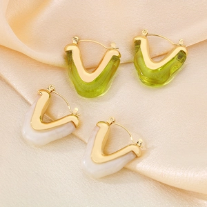 Colorful V-shaped stainless steel drip oil hoop earrings on champagne silk fabric