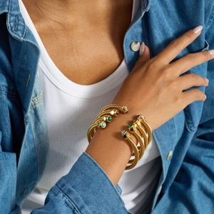 Detail of gold twisted cable open cuff bracelet inlaid with malachite and turquoise gems