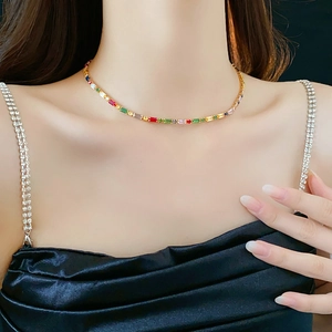 Detail of gold plated necklace featuring vibrant colorful square zircon gemstones