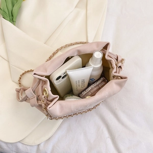 Pink drawstring bucket bag with chain strap showing spacious interior for daily items