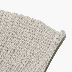 Close-up of oatmeal knitted beanie showing premium textured stitch and soft wool fabric