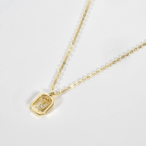 Detail of S925 silver necklace featuring a gold letter V pendant with clear crystals