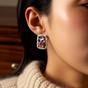 Close-up of vintage square stud earrings with colorful glass beads and zircon on ear