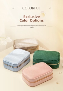 Overhead view of colorful velvet jewelry cases in pink, blue, green and beige