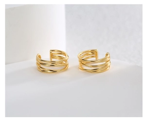 Detail view of gold-plated multi-layer coiled metal ear cuffs for non-pierced ears