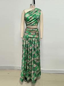 Detail of tropical leaf print two-piece set featuring asymmetrical one-shoulder crop top