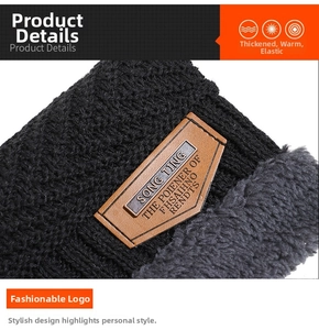 Detail of black winter knit hat featuring thick grey fleece lining and premium leather logo