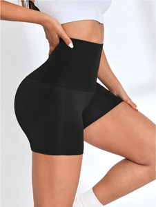 Close-up of high-waisted sauna shorts showing slimming tummy control and butt lifting effect
