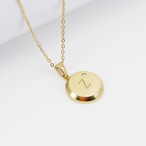 Detailed macro view of 18K gold letter Z pendant with a tiny cubic zirconia stone