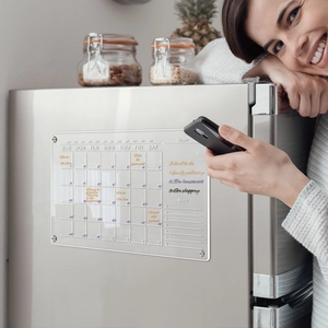 Lifestyle shot of transparent acrylic magnetic weekly calendar for fridge with handwritten notes