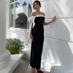 Detail showing the large white bow on off-shoulder black slimming long dress