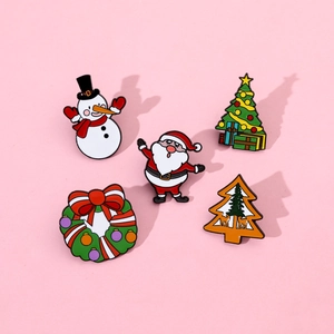 Detailed view of five festive enamel Christmas pins including Santa, Snowman and Wreath