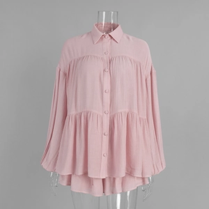 Detail of pink ruffled shirt showing textured fabric and lantern sleeve design
