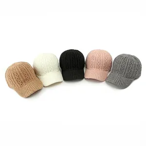Knitted baseball caps in five neutral colors with textured cable knit and curved brim