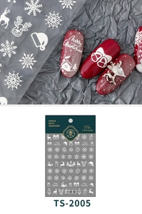 Detail of Christmas nail art stickers with white embossed snowflakes and reindeer designs