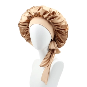 Champagne gold satin sleep cap with wide elastic ribbon band shown on a model head