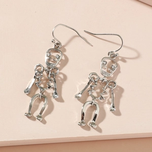 Macro detail of punk skeleton drop earrings with sparkling rhinestones and silver finish