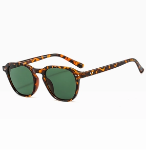 Detail view of retro sunglasses with tortoiseshell frame and dark green lenses