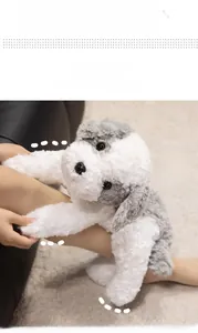 Detail of soft grey and white plush puppy toy with realistic curly fur texture