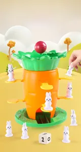 Detail view of carrot balance tower game with bunny pieces, dice, and red ball for kids