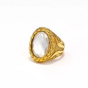 Detail of gold mens ring with oval clear gemstone and braided rope texture on stainless steel