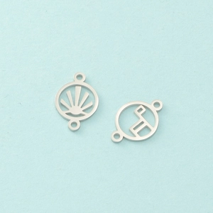 Close-up of two silver sunburst geometric metal charms with double loops for DIY jewelry