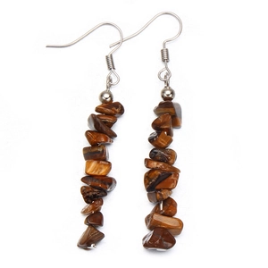 Close-up of dangling natural tiger eye stone earrings with polished crystal beads