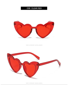 Detail view of heart-shaped sunglasses in clear red with a lightweight resin frame