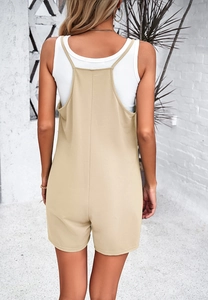 Back view of women's khaki overall shorts with pocket, styled with a white top